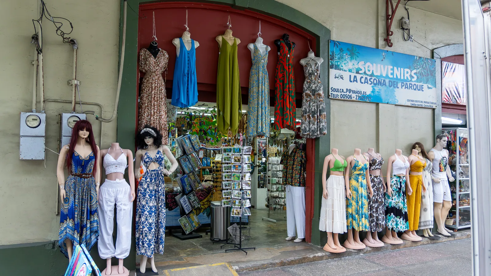 Shop front with hanging dresses and mannequins on the sidewalk
