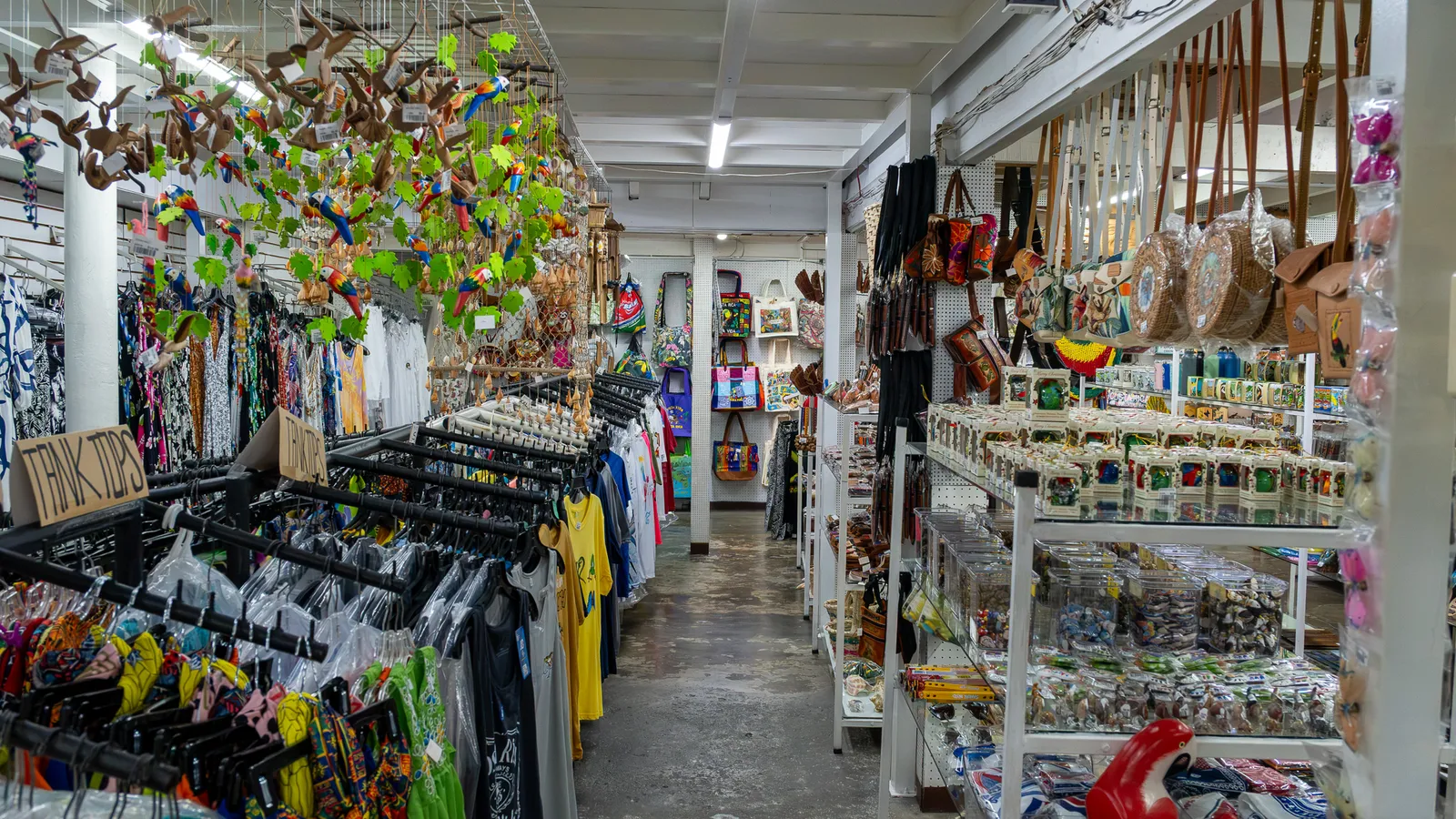 Aisle with clothing, hanging mobiles and souvenir shelves