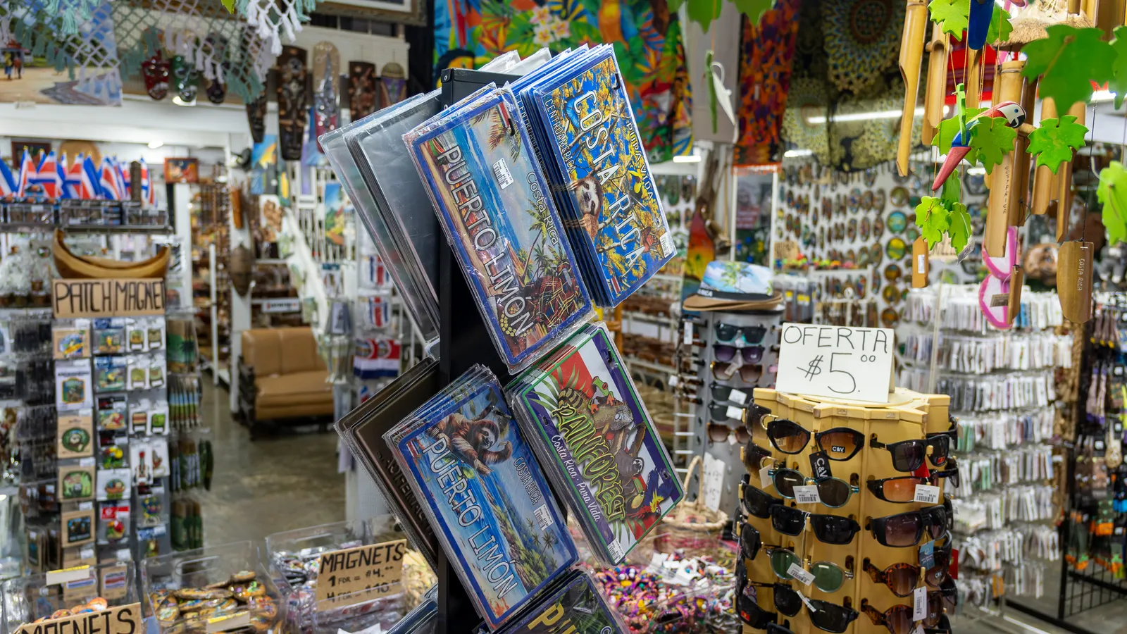 Rack of Puerto Limón posters and sunglasses on sale