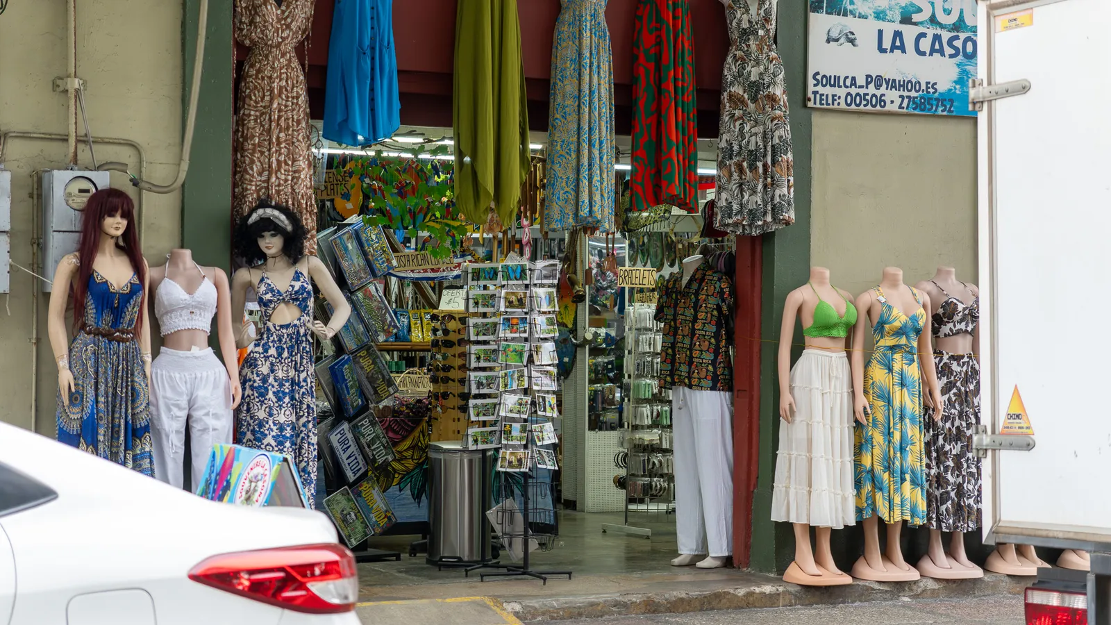 Shop entrance with mannequins and postcard racks